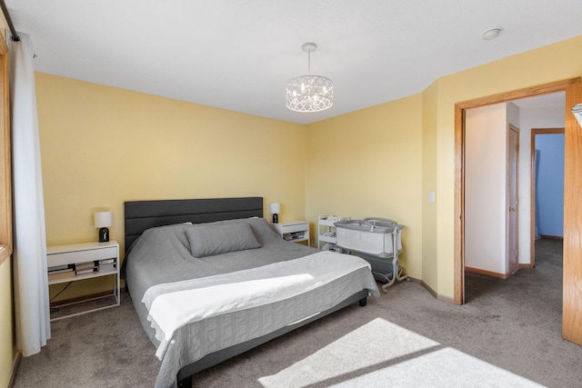 bedroom with baseboards, carpet floors, and a chandelier