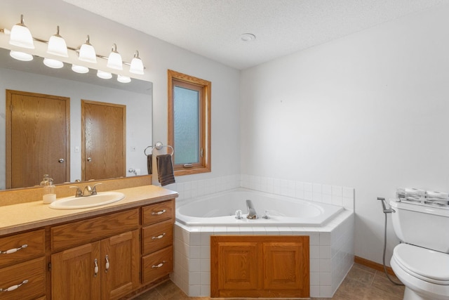 bathroom featuring tile patterned floors, toilet, a textured ceiling, a bath, and vanity