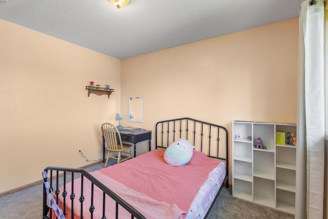 bedroom with baseboards, carpet floors, and a textured ceiling