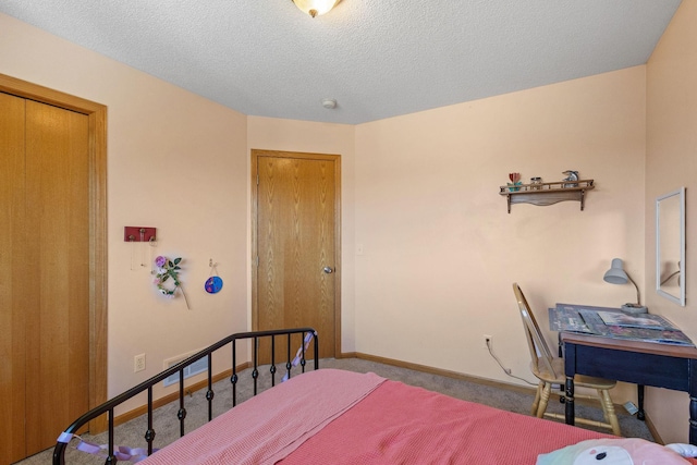 carpeted bedroom featuring baseboards and a textured ceiling