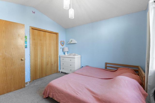 bedroom with a closet, carpet, and vaulted ceiling