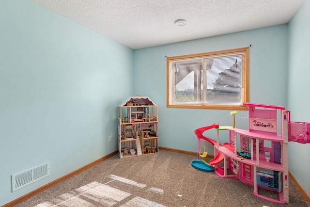 rec room with carpet flooring, baseboards, visible vents, and a textured ceiling