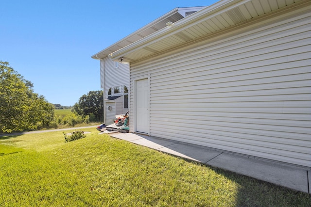 view of side of home with a lawn