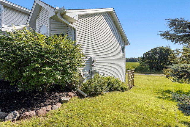 view of side of home featuring a lawn