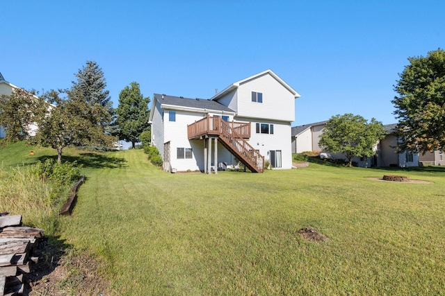 rear view of property featuring stairs, an outdoor fire pit, a yard, and a wooden deck