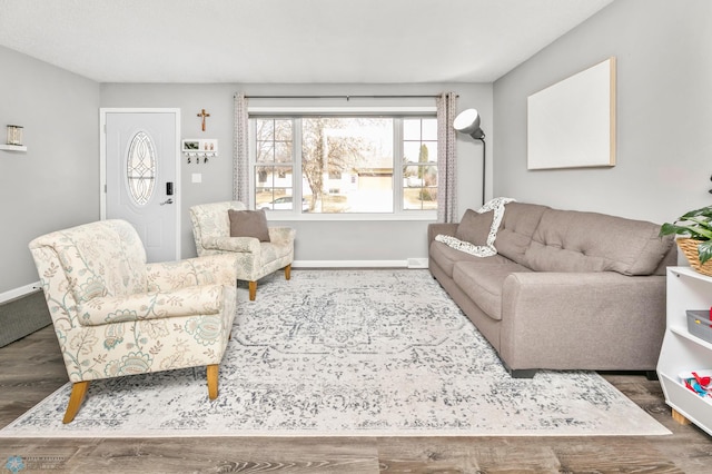 living area featuring baseboards and wood finished floors