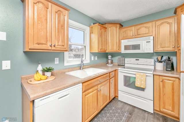 kitchen featuring a sink, light countertops, white appliances, a textured ceiling, and dark wood-style flooring