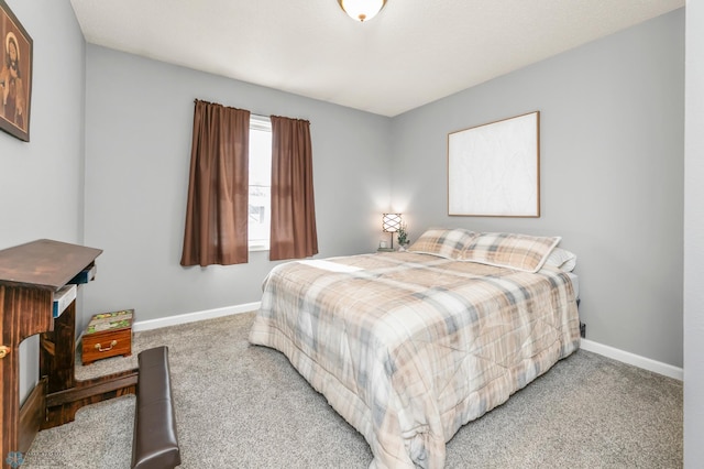 bedroom featuring baseboards and carpet flooring