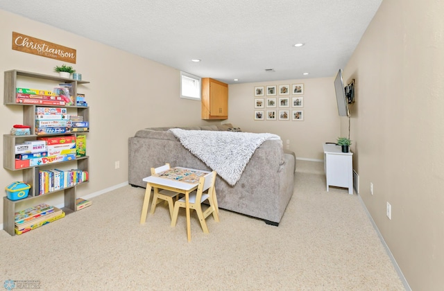 living room with recessed lighting, baseboards, a textured ceiling, and light carpet