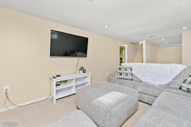 living room with recessed lighting, a textured ceiling, stairs, and carpet floors