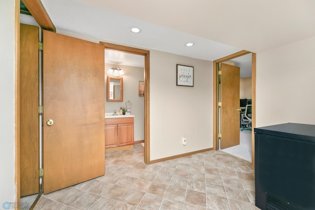 hallway featuring recessed lighting and baseboards