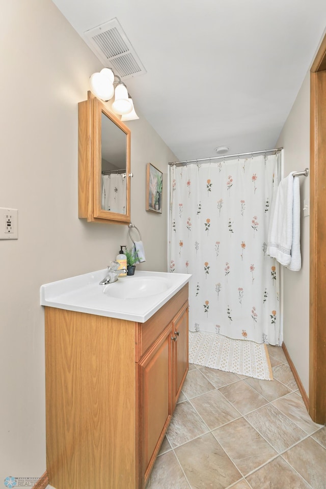 bathroom featuring tile patterned floors, visible vents, vanity, and a shower with shower curtain