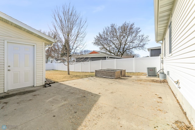 view of yard featuring central AC, a patio, and fence