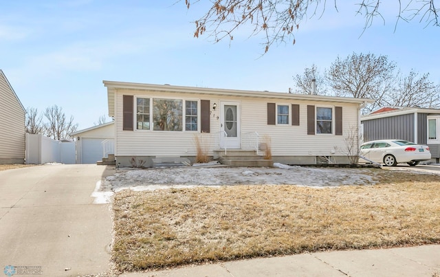 view of front of property with fence, an outbuilding, and entry steps