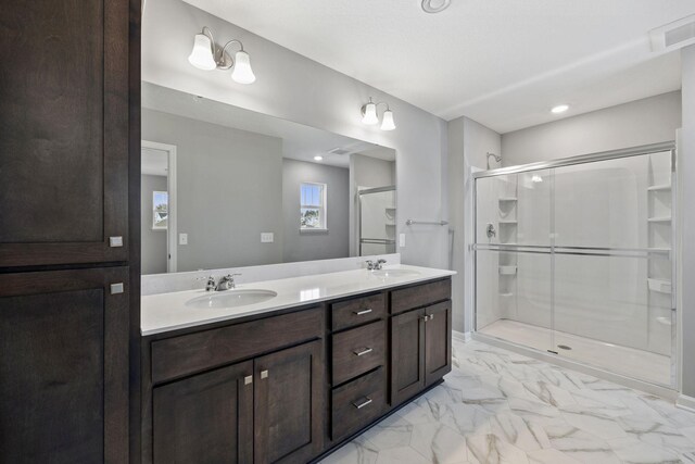 bathroom with visible vents, marble finish floor, a stall shower, a sink, and double vanity