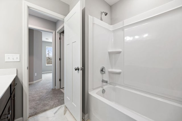 full bath with vanity, tub / shower combination, marble finish floor, and baseboards