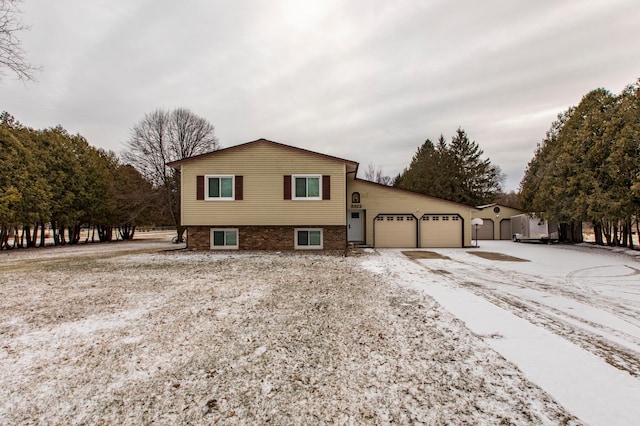 view of front of house featuring an attached garage and brick siding