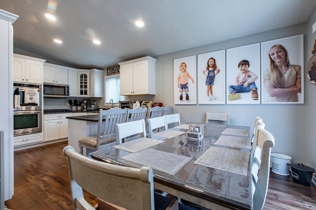 dining area featuring lofted ceiling, recessed lighting, and dark wood-style floors