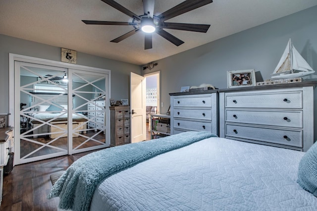 bedroom with dark wood finished floors, a ceiling fan, and a textured ceiling