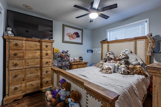 bedroom with dark wood finished floors, a textured ceiling, and ceiling fan