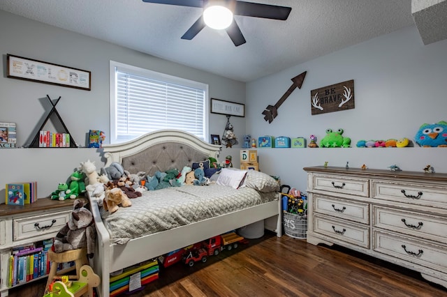 bedroom with a textured ceiling, a ceiling fan, and wood finished floors