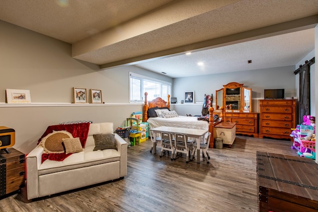 bedroom with a textured ceiling and wood finished floors