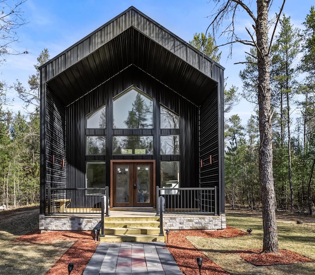 property entrance with a porch and french doors