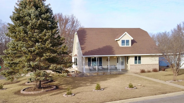 cape cod house featuring covered porch