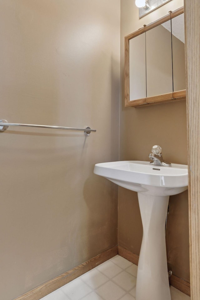 bathroom with baseboards and a sink