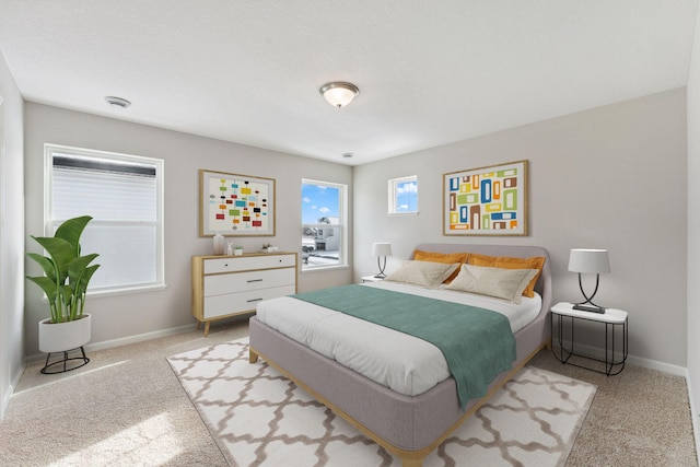 bedroom with carpet flooring and baseboards