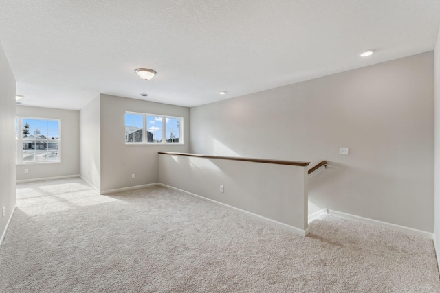 unfurnished room featuring baseboards and carpet