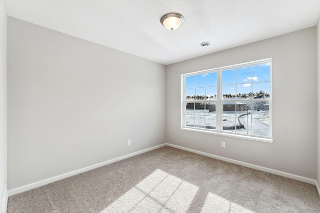 carpeted spare room with baseboards