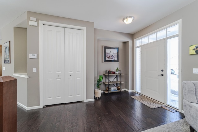 entryway featuring dark wood-style floors and baseboards