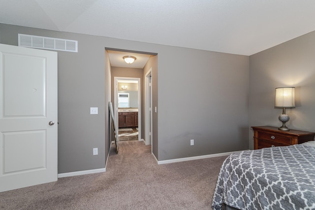 carpeted bedroom featuring baseboards and visible vents