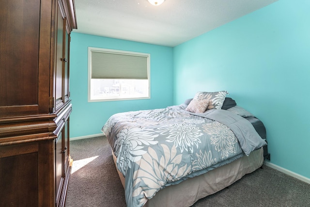 bedroom featuring baseboards and carpet floors