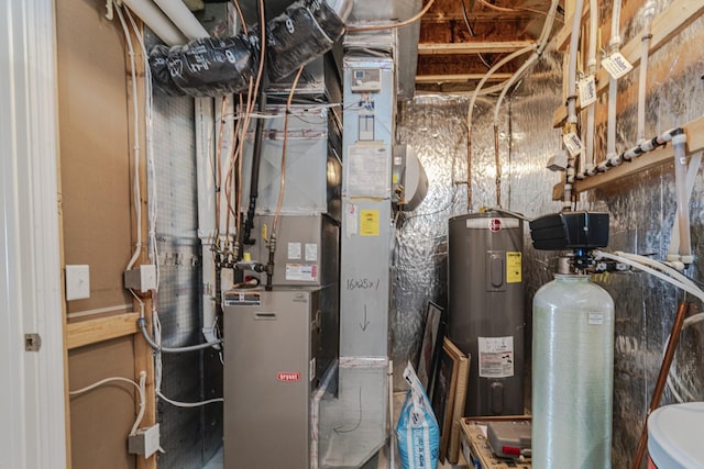 utility room featuring heating unit and water heater