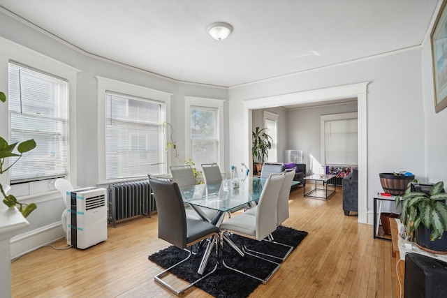 dining room featuring radiator and light wood finished floors