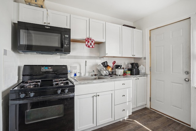 kitchen featuring black appliances, a sink, dark wood finished floors, white cabinets, and decorative backsplash