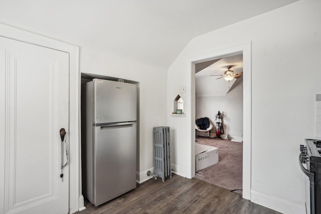 kitchen with dark wood-style floors, freestanding refrigerator, radiator, baseboards, and ceiling fan