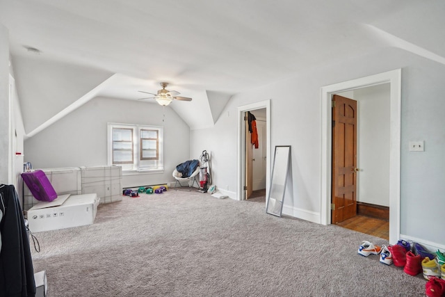 recreation room featuring baseboards, carpet floors, ceiling fan, and vaulted ceiling