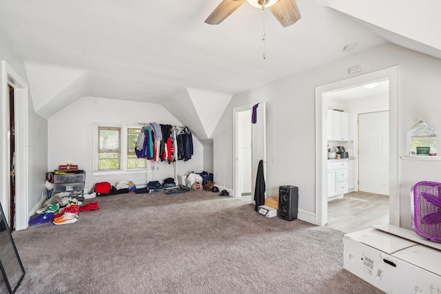 additional living space featuring lofted ceiling, light carpet, and ceiling fan