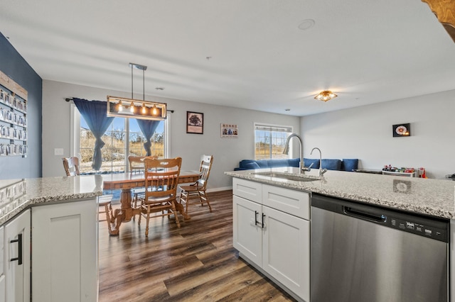 kitchen with dark wood-type flooring, a sink, white cabinetry, light stone countertops, and dishwasher