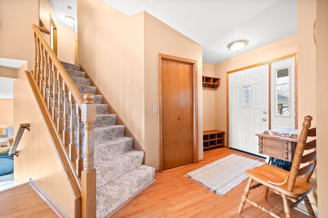 entrance foyer featuring wood finished floors and stairs