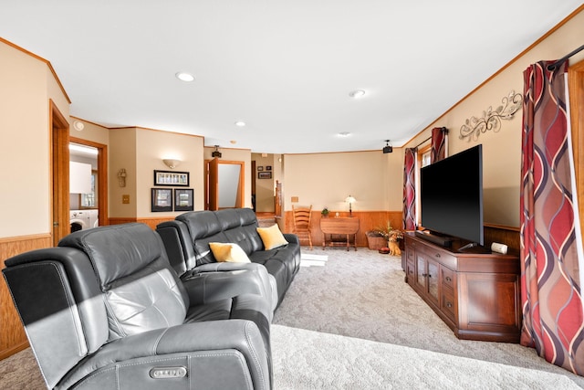 living room with wooden walls, carpet, washer / dryer, and wainscoting