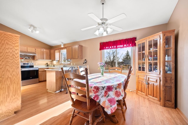 dining area with lofted ceiling, a ceiling fan, and light wood-type flooring