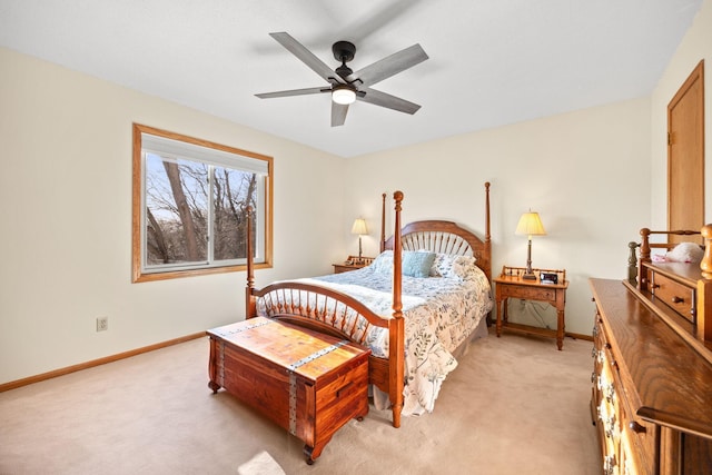 bedroom featuring light carpet, a ceiling fan, and baseboards