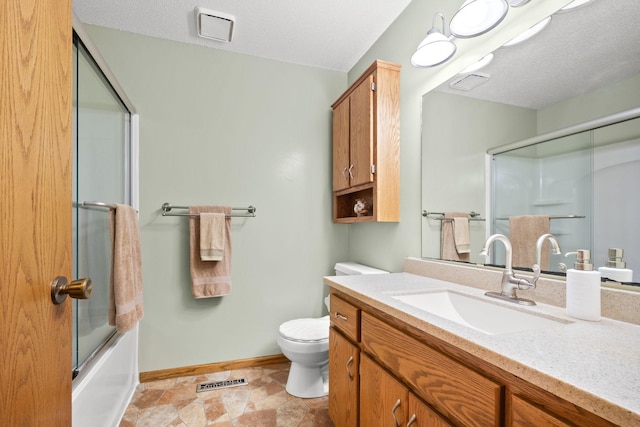 bathroom with visible vents, baseboards, toilet, vanity, and a textured ceiling