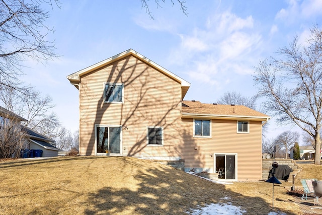 rear view of property with a lawn