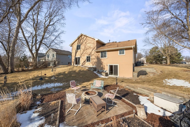 rear view of house with a patio and an outdoor fire pit