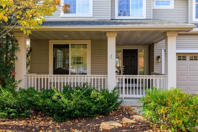 property entrance with covered porch and a shingled roof